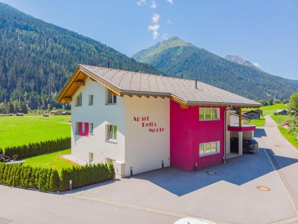an art firm white building with mountains in the background at Apartment Bella Monte-1 by Interhome in Pettneu am Arlberg