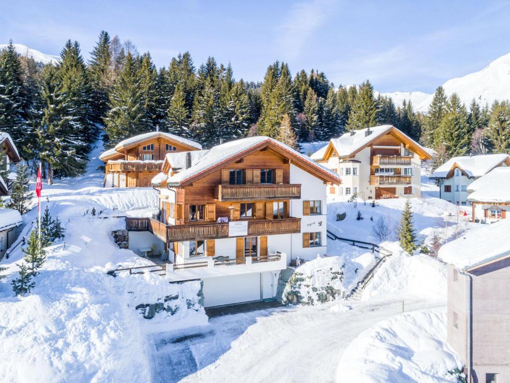 a ski lodge in the mountains in the snow at Apartment Tga Stgirat Obergeschoss by Interhome in Malmigiuer
