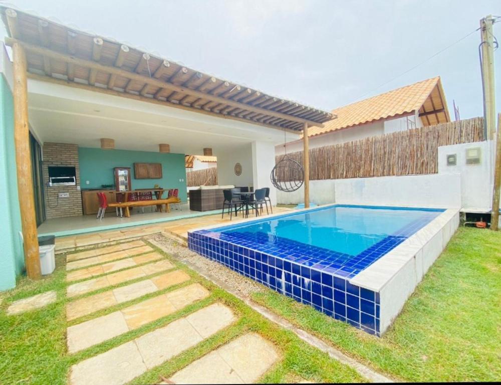 a swimming pool in the backyard of a house at Casa Patacho in Pôrto de Pedras