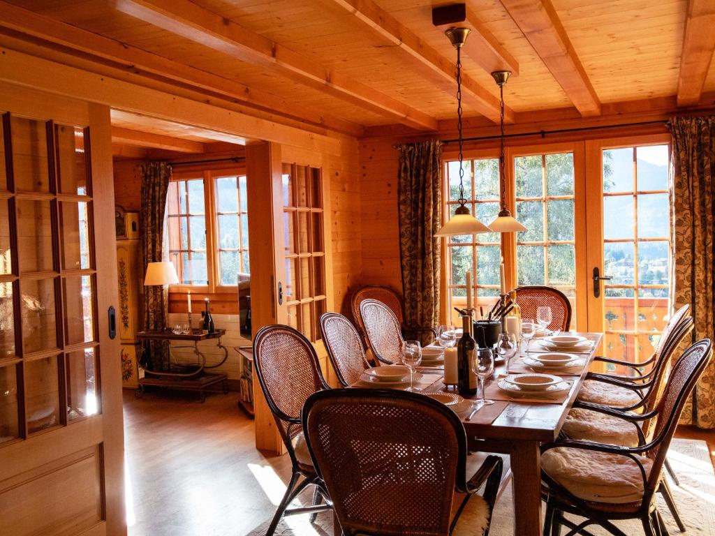 a dining room with a long table and chairs at Apartment La-Ina by Interhome in Chesières