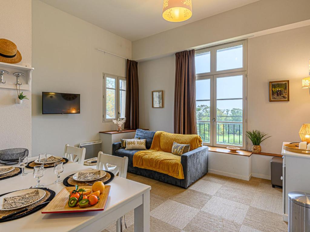 een woonkamer met een bank en een tafel bij Apartment Le Château de Kergonano-14 by Interhome in Baden