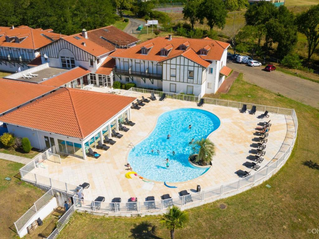 an aerial view of a swimming pool in front of a house at Apartment Les Hameaux de La Chalosse-3 by Interhome in Cassen