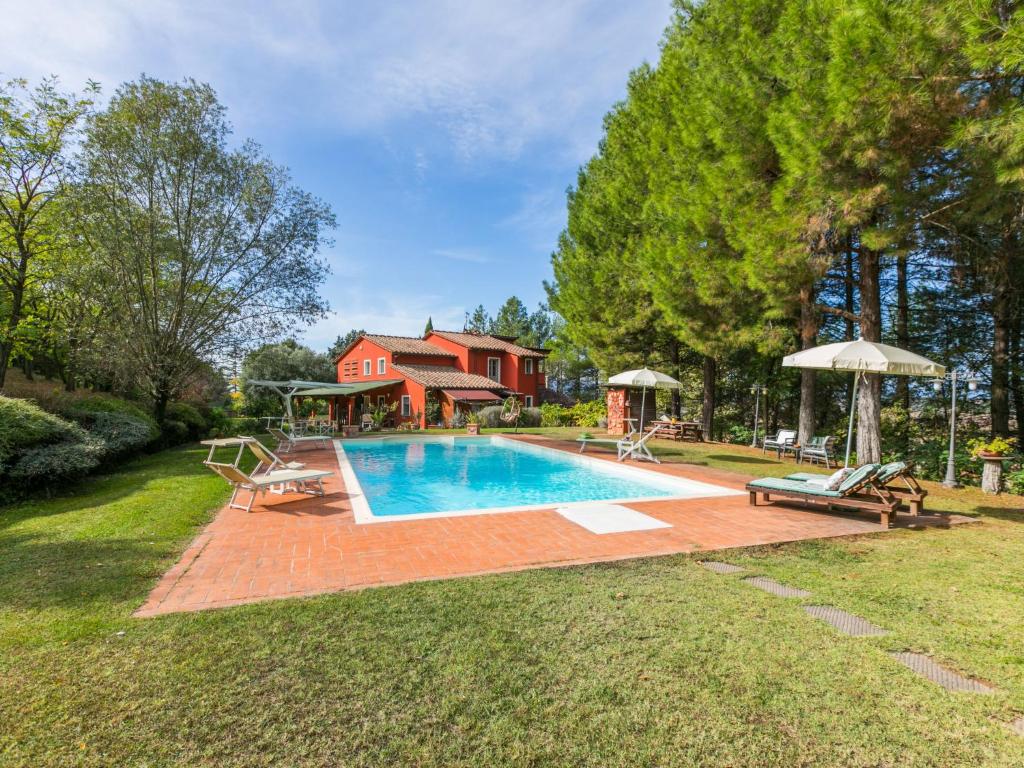 a swimming pool in a yard next to a house at Holiday Home Casale il Poggio by Interhome in Fucecchio