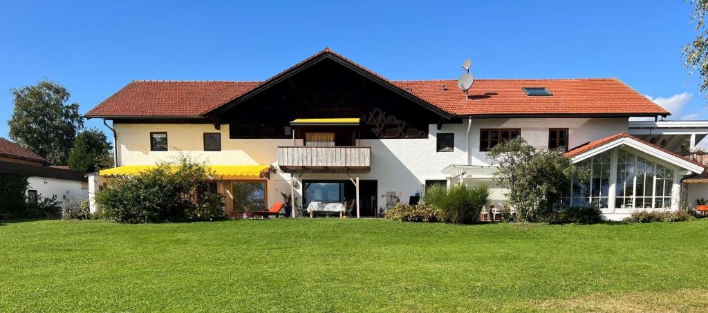 a large house with a green lawn in front of it at Ferienhaus zur schönen Aussicht in Teisendorf