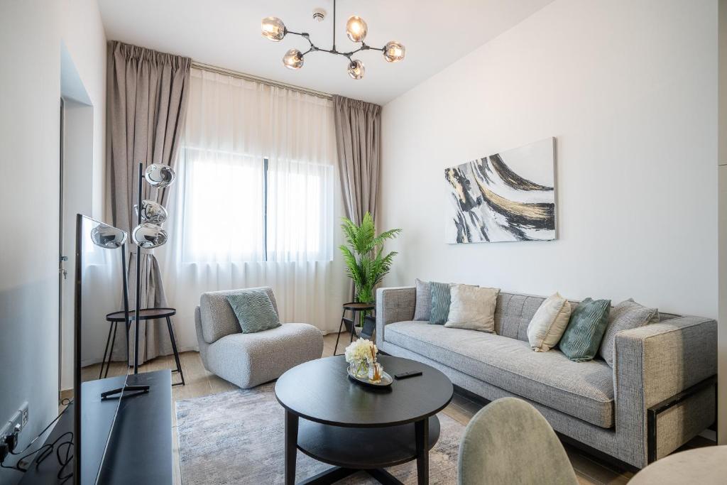 a living room with a couch and a table at ALH Vacay - The Nook 1 - 2 Bedrooms - Near Metro in Dubai