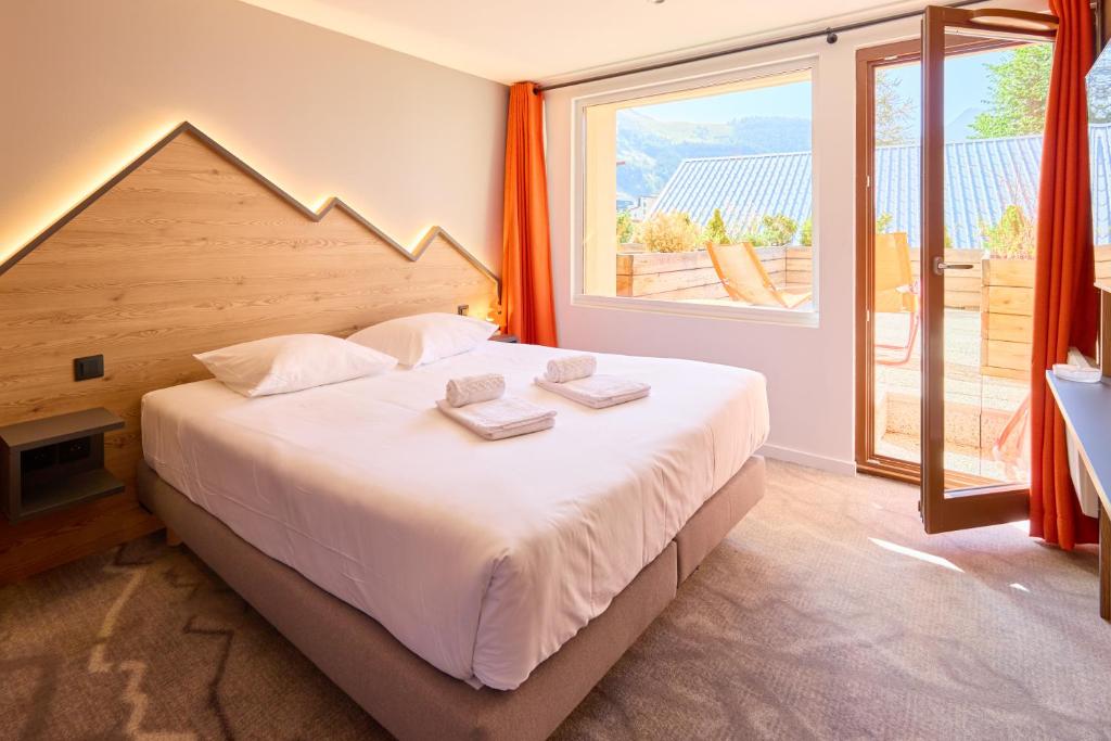 Postel nebo postele na pokoji v ubytování Hotel Base Camp Lodge - Les 2 Alpes