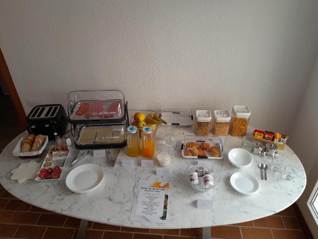 a table with food and drinks on top of it at DJM Palms B&B - No es una casa privada in Ayora