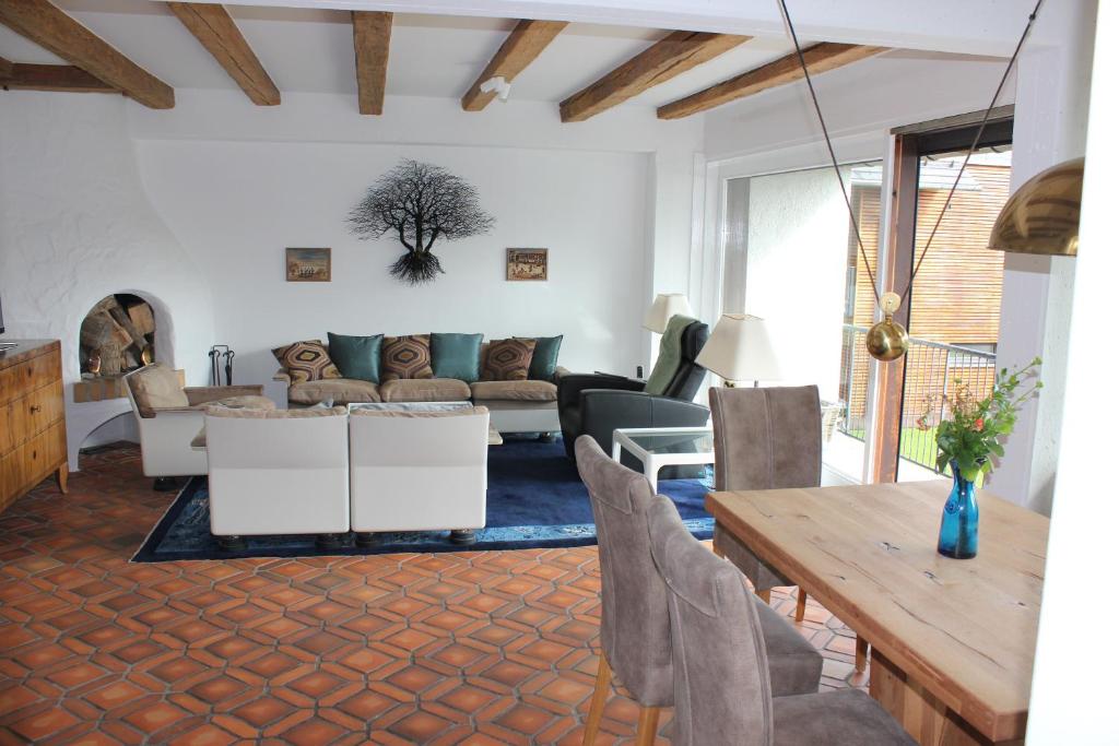 a living room with a couch and a table at Schatzlhof Suite in Berg am Starnberger See in Berg am Starnberger See