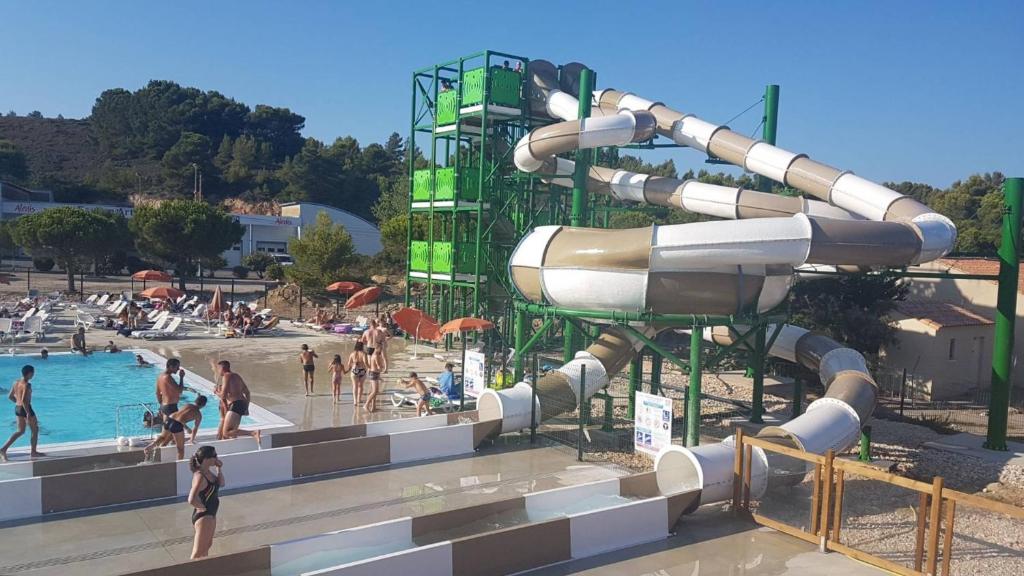 a water slide at a water park with people in it at Mobil-home cosy 166 in Narbonne