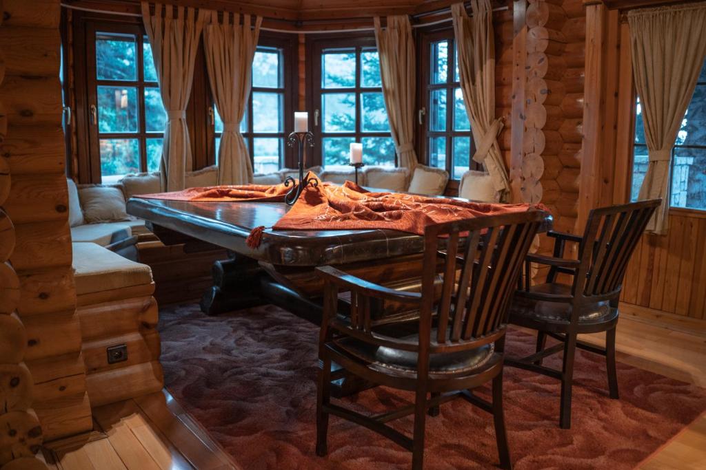 a dining room with a wooden table and chairs at 7Hills Finnish Luxury Chalet by Ski Alure in Eptalofos