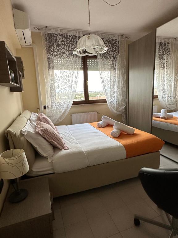 a bedroom with a bed with an orange blanket and a window at THE HOUSE OF SUNSETS in Rome