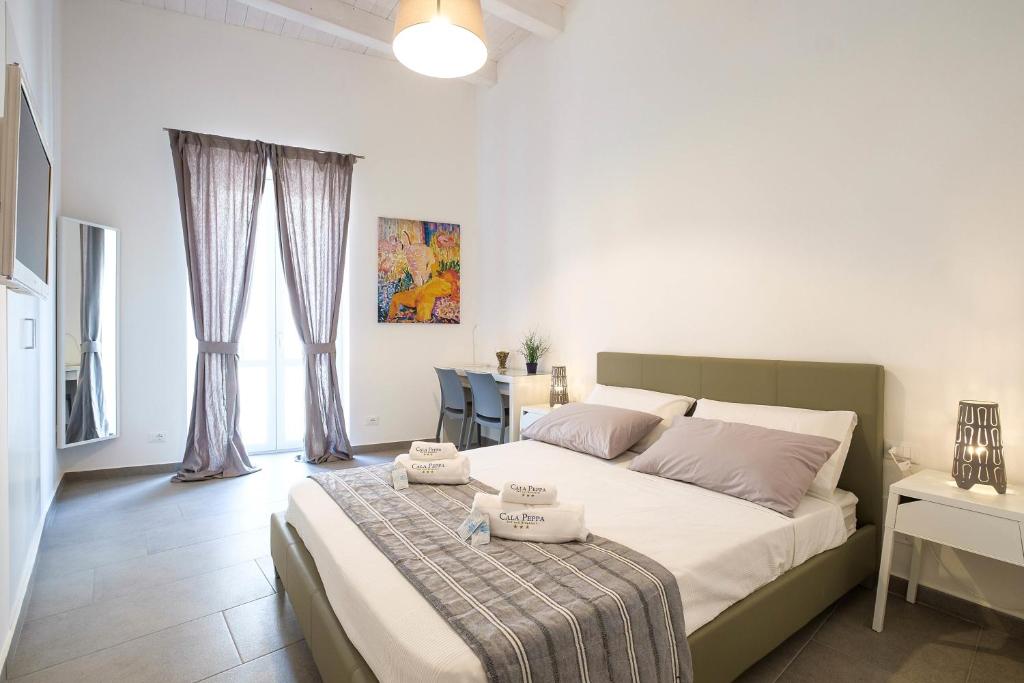 Posteľ alebo postele v izbe v ubytovaní B&B Cala Peppa