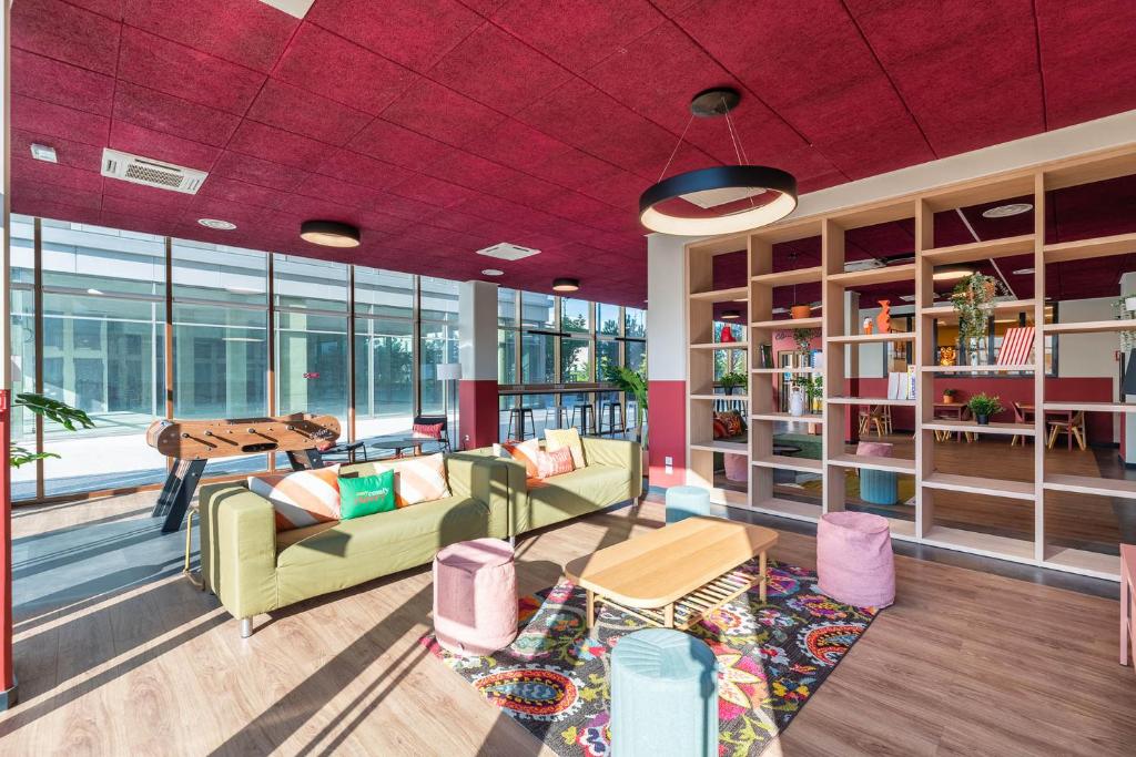 a living room with a couch and chairs and a table at Student Factory Lyon Parilly in Vénissieux