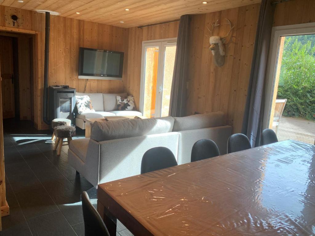 a living room with a couch and a table at Chalet Barcelonnette in Barcelonnette