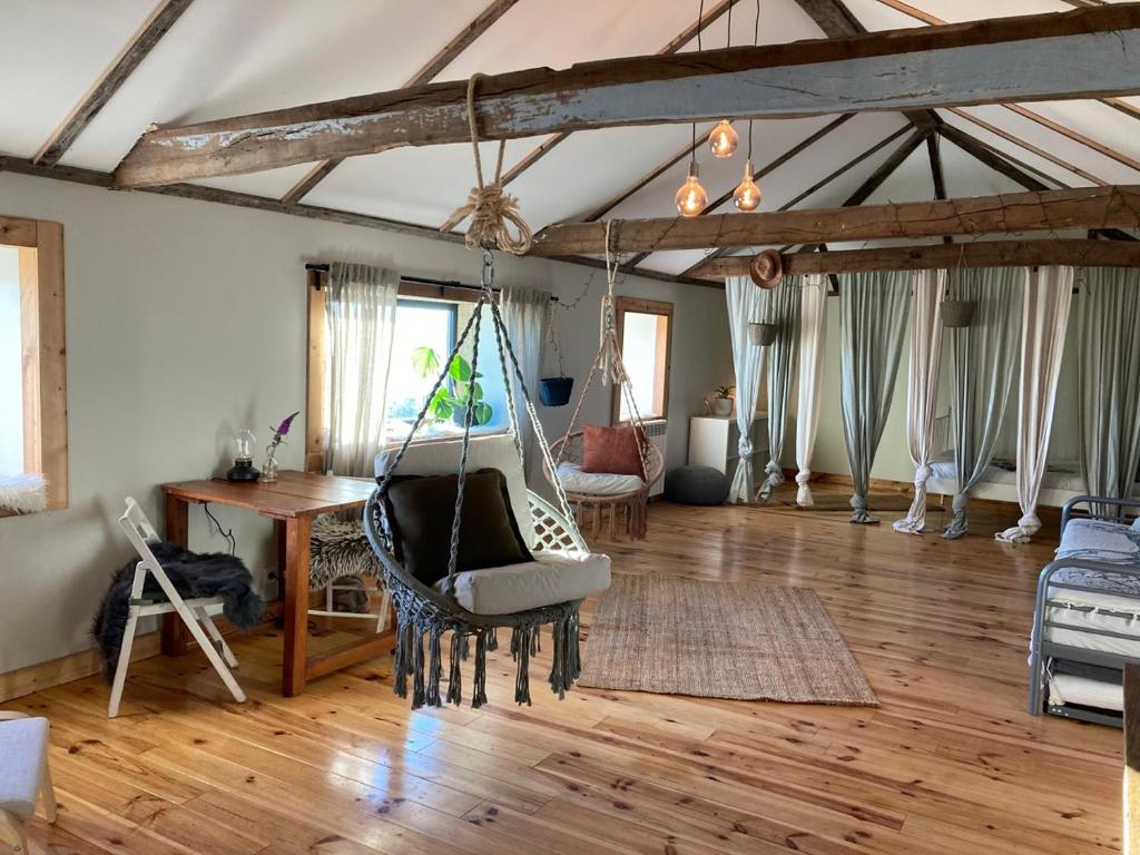 a living room with a hammock hanging from a ceiling at The Loft With a View in Cabeceiras de Basto