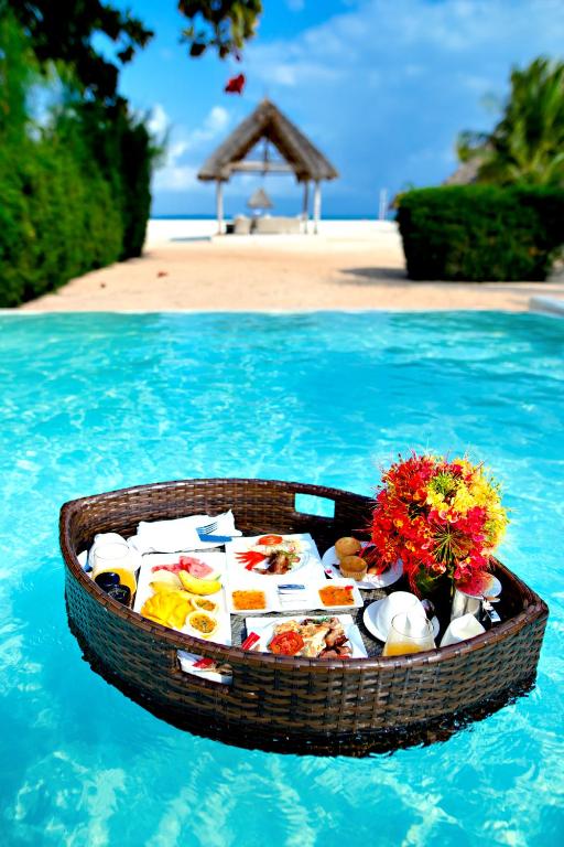a basket of food in the water in a swimming pool at Gold Zanzibar Beach House & Spa in Kendwa