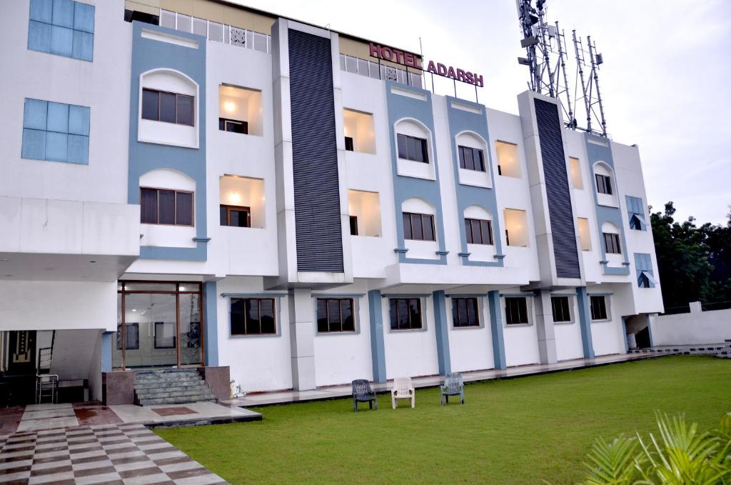 a building with a lawn in front of it at Hotel Adarsh in Aurangabad