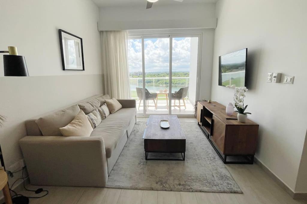 a living room with a couch and a table at Beautiful Penthouse with private elevator in Hard Rock Golf in Punta Cana