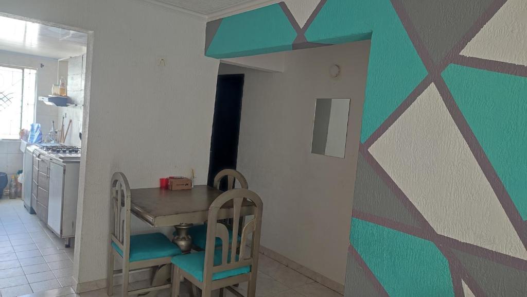 a kitchen with a table and chairs in a room at Habitaciónes El Mirador in Cartagena de Indias