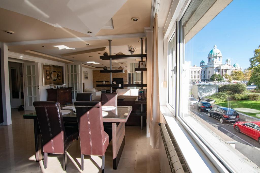a dining room with a view of the city at Sweet House Parlament Lux in Belgrade