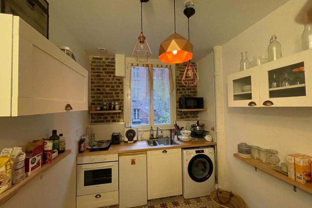 a kitchen with a sink and a washing machine at Lovely love nest near Paris in Clichy