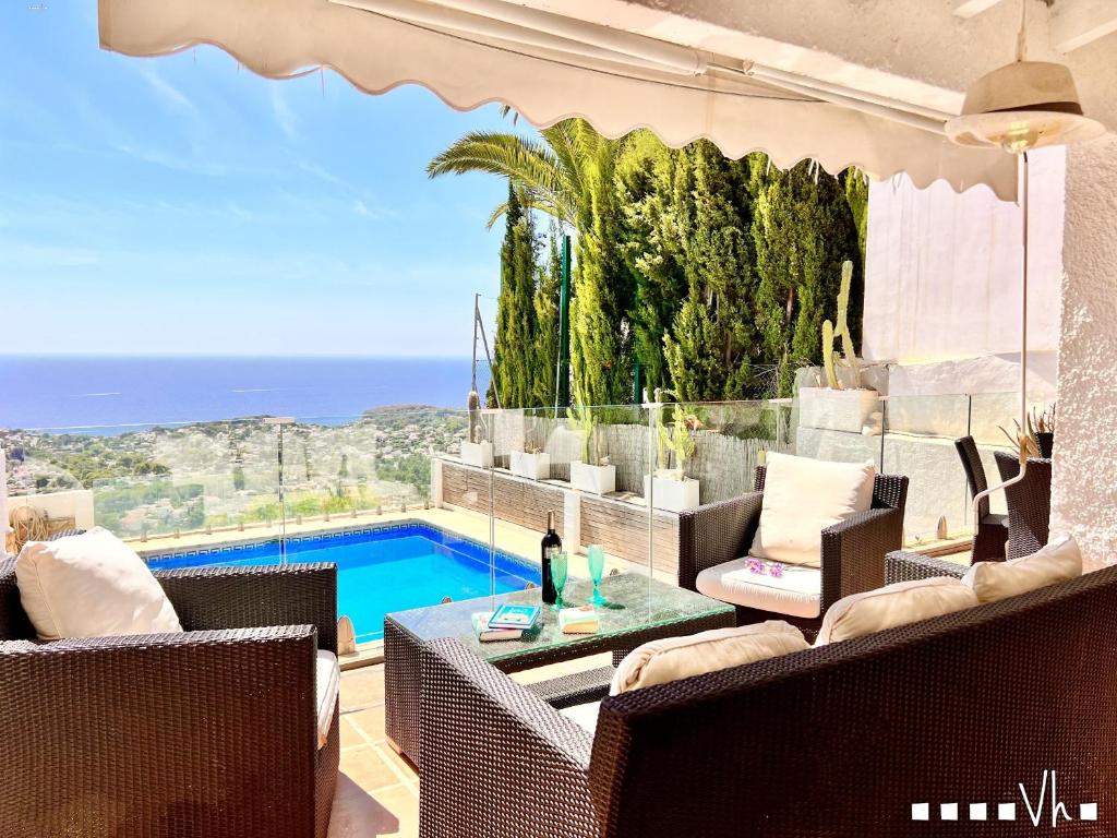 a villa with a view of a swimming pool at VH CostaBlanca - VANILLA in Benissa