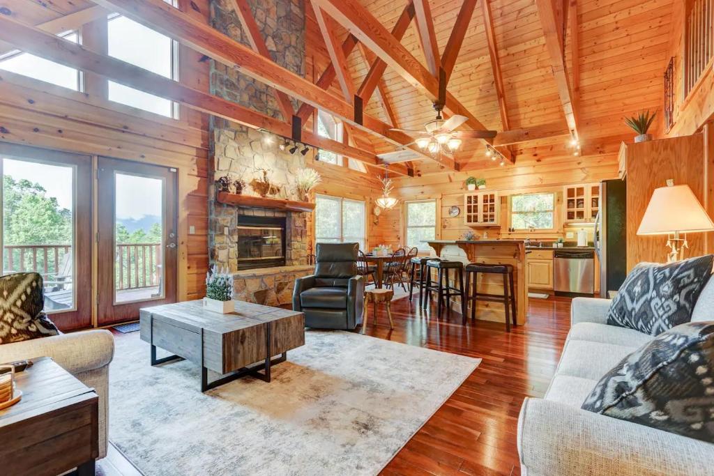 a living room with a couch and a table at LUX 4BD Lodge w/ Views! Fire Pits + HOT TUB + Pool in Gatlinburg