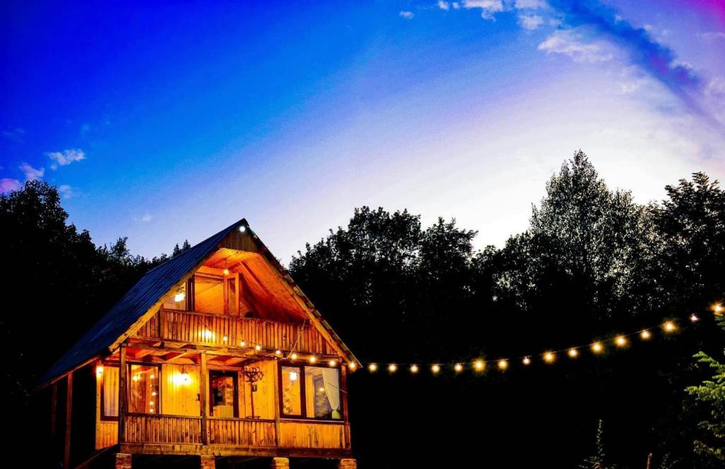 a house with a string of lights around it at Cottage Racha Rhymes in Ambrolauri