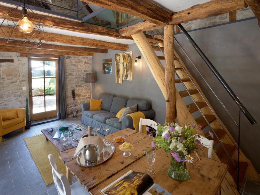 a living room with a table and a couch at Moulin des Borderies in Singles