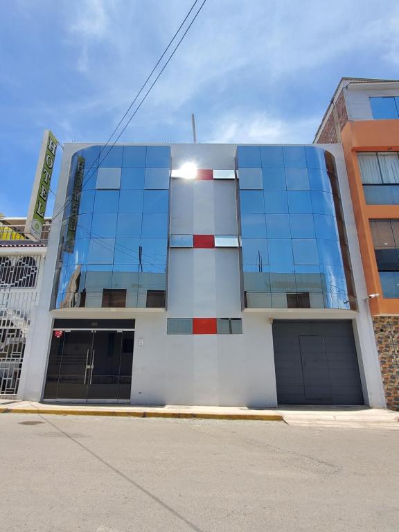 a building with glass windows on the side of it at Hotel Real San Pedro in El Puente