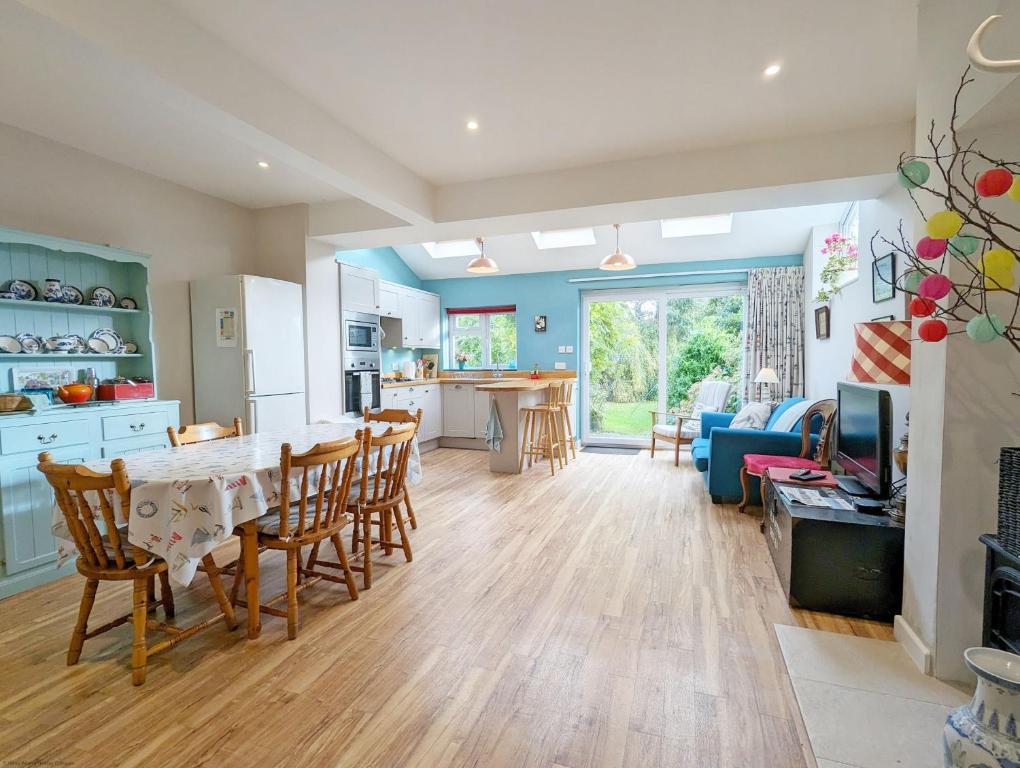 a kitchen and living room with a table and chairs at Thorney Road in Emsworth
