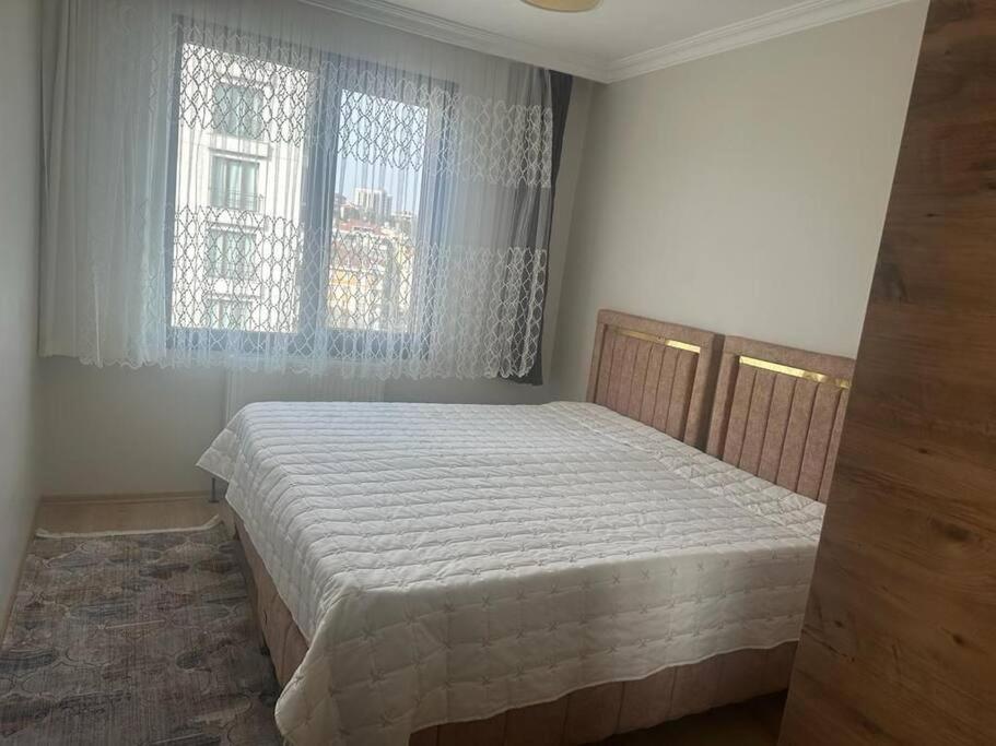 a bedroom with a bed and a window at Apartment with nice view in Beylikduzu