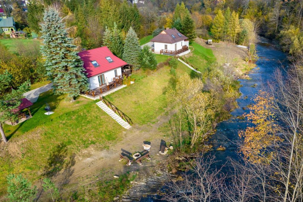 an aerial view of a house next to a river at Nad Wilczym Potokiem in Baligród