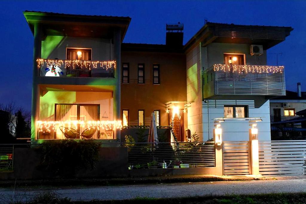 a house with lights on the side of it at night at Andromache's Cozy Villa close to Meteora-Trikala in Tríkala