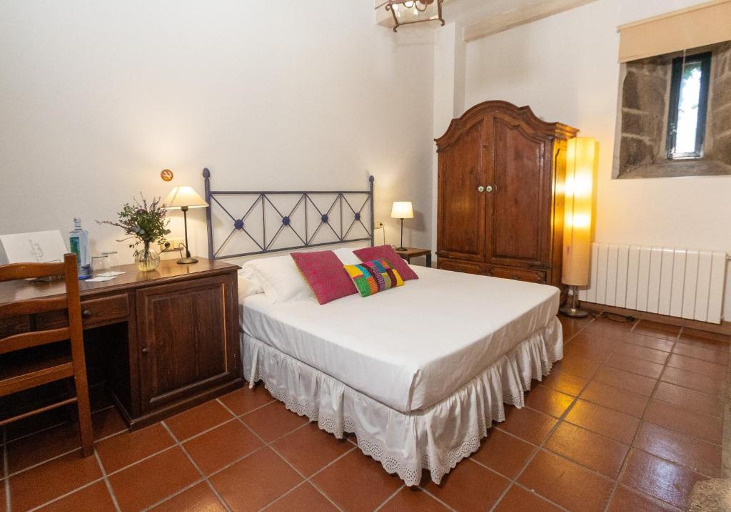 Schlafzimmer mit einem Bett, einer Kommode und einem Schreibtisch in der Unterkunft Rectoral de Cobres 1729 in San Adrian de Cobres