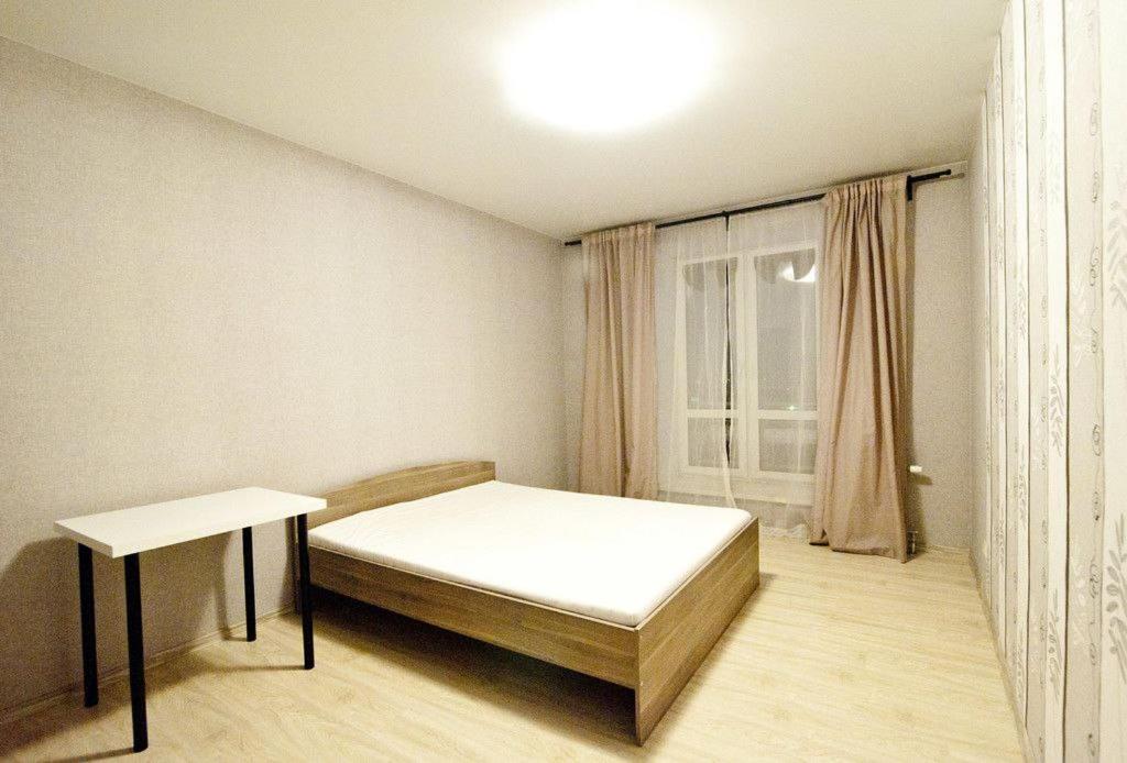 a small bedroom with a bed and a table at City Centre Vip 202 in Tbilisi City