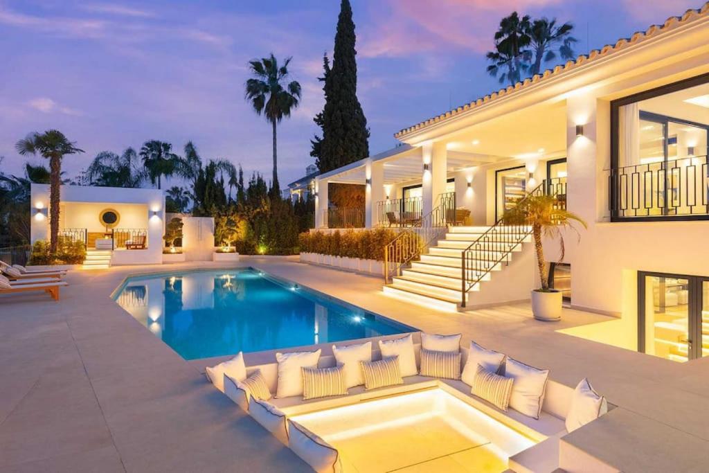 a villa with a swimming pool and a house at Villa Mercedes - Luxury 5-Bedroom Villa in Las Brisas, Marbella in Marbella