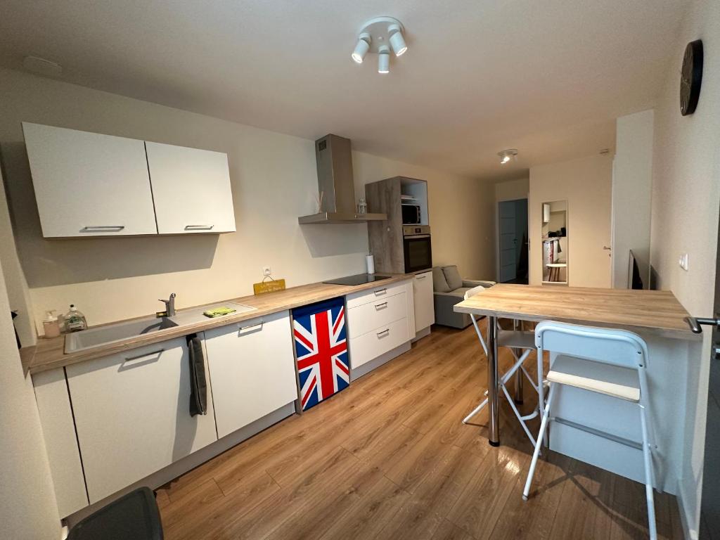 a kitchen with a kitchen island with a british flag on it at T2 hyper centre LONS LE SAUNIER in Lons-le-Saunier