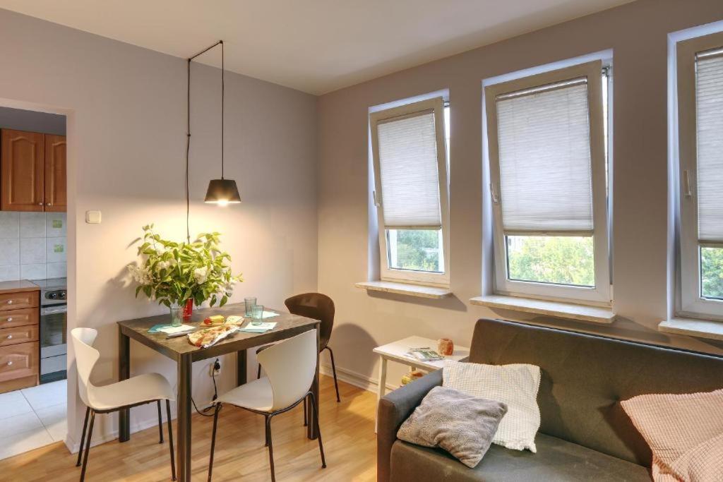 a living room with a table and a couch at Bielany P&O Apartments in Warsaw