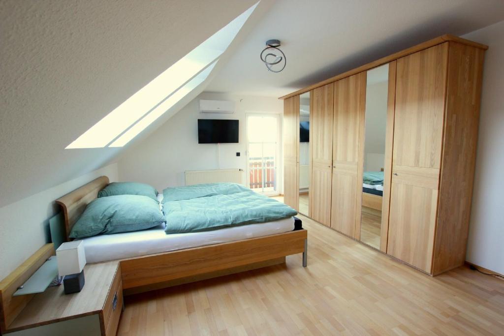 a bedroom with a bed and a skylight at Ferienwohnung zur Bugspitze in Selbitz