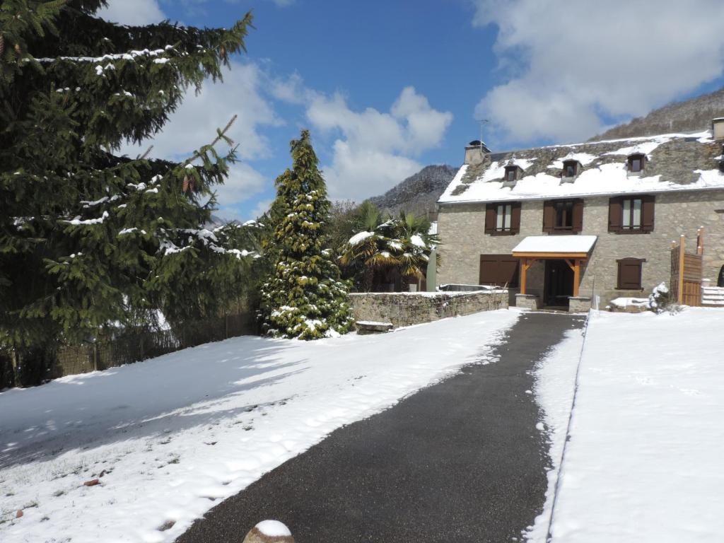 a house with a snow covered driveway at Gîte d&#39;AURE. Classé en meublé 4 étoiles. 