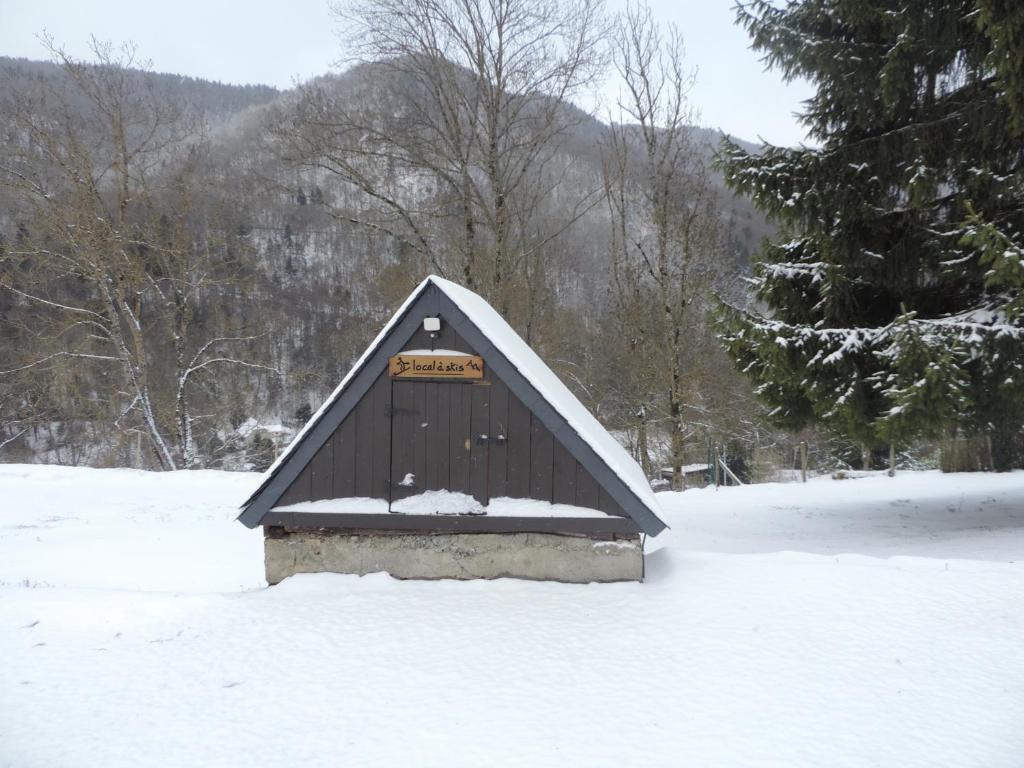 a small building with a sign on it in the snow at Gîte d&#39;AURE. Classé en meublé 4 étoiles. 