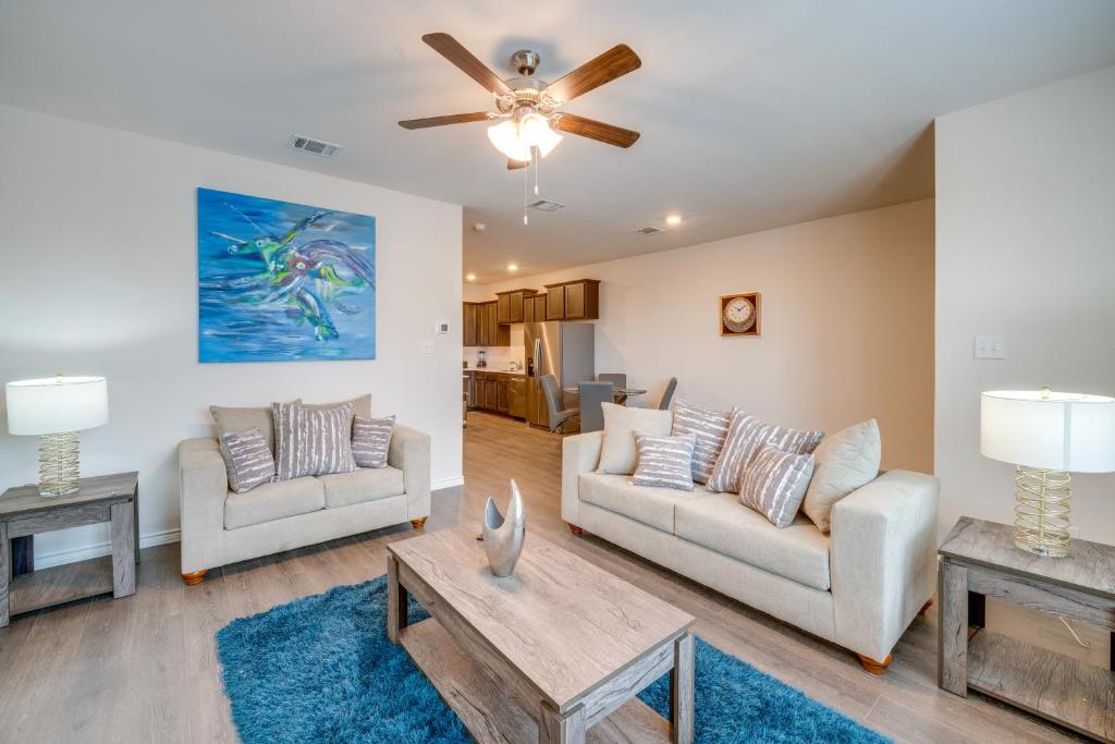 a living room with two couches and a table at Chic Mesquite Townhome about 11 Mi to Downtown Dallas! in Mesquite