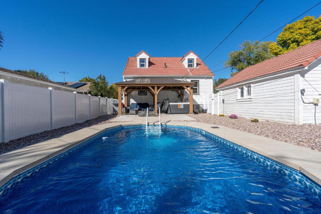a swimming pool in front of a house at Charming Salt Lake City Home Minutes from Airport, Downtown SLC , Skiing in South Salt Lake