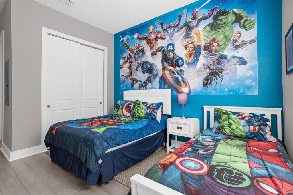 a bedroom with two beds and a marvel mural at Magical Vacation Home 3 min from Disney in Orlando