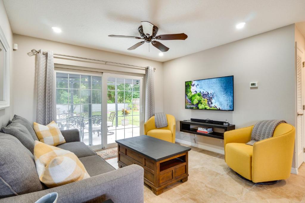 a living room with a couch and a tv at Family-Friendly Home in Casselberry with Fire Pit! in Orlando
