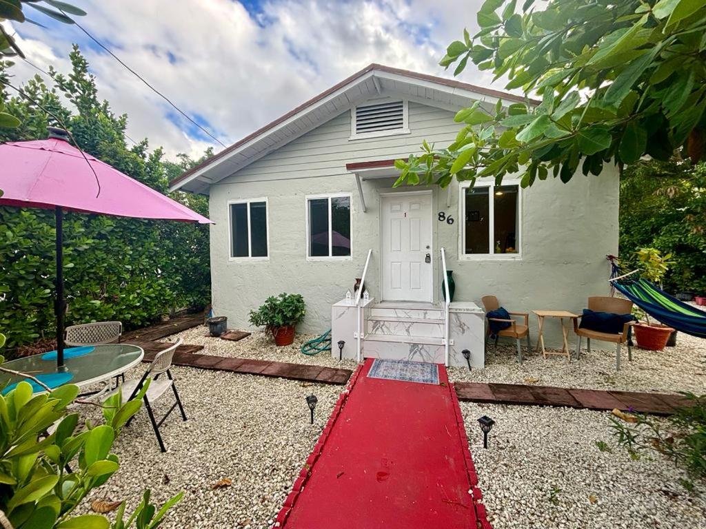 a house with a red pathway in front of it at Nice Queen Bedroom - Best Location in Miami - Luggage Storage Service, Parking and Laundry for free!!!! in Miami