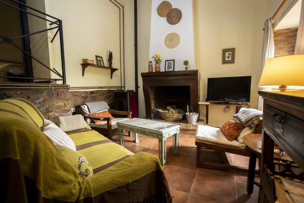a living room with a couch and a fireplace at Pozuelo 3 JABUGO in Jabugo