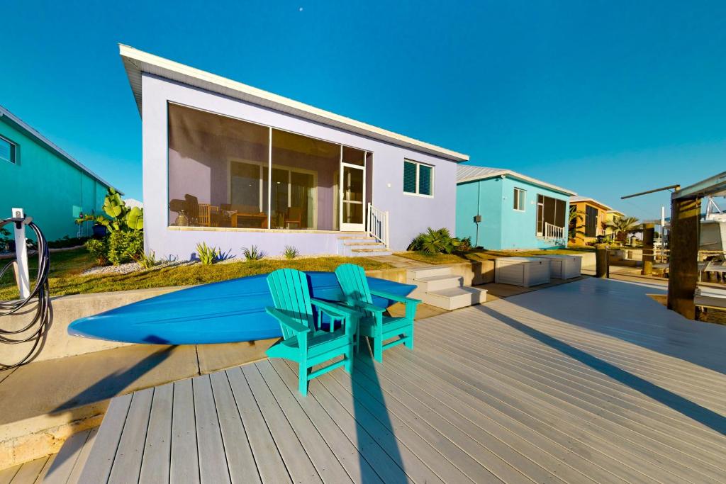 a house with two blue chairs on a deck at Lavender Life in Saint James City
