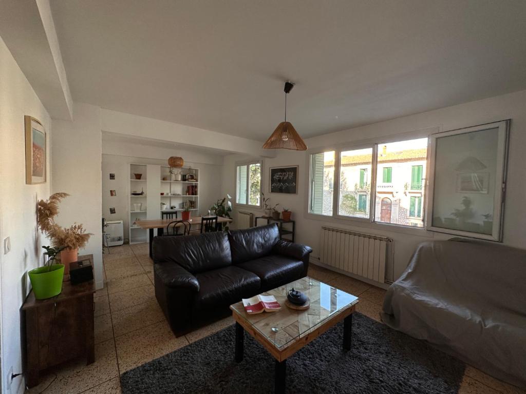 un salon avec un canapé et une table basse dans l'établissement Chambres dans Grand Appartement - Centre-ville, à Montpellier